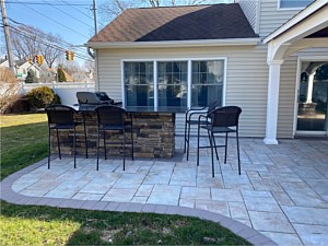 boral southern ledgestone bucks county cultured stone outdoor kitchen bbq area with bar seating chesapeake alpine brick pavers brown border